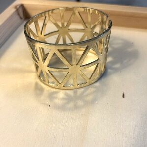 Gold color cuff bracelet.